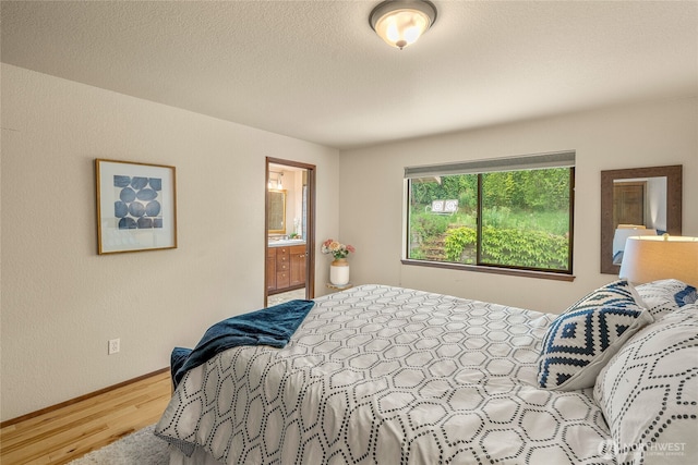 5510 3rd Ave NW, Seattle, WA 98107 - bedroom with wood finished floors, baseboards, and ensuite bathroom
