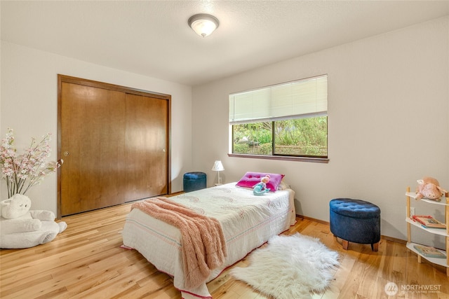 5510 3rd Ave NW, Seattle, WA 98107 - bedroom featuring a closet, wood finished floors, and baseboards