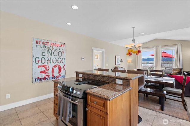 kitchen featuring vaulted ceiling, dark stone countertops, a chandelier, electric range, and brown cabinets