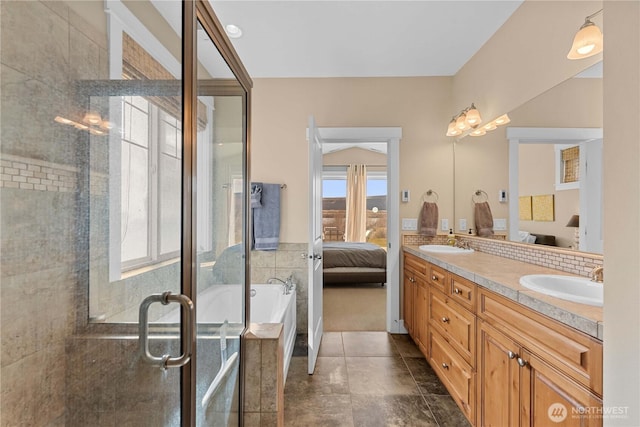 bathroom featuring ensuite bath, a sink, double vanity, and a shower stall
