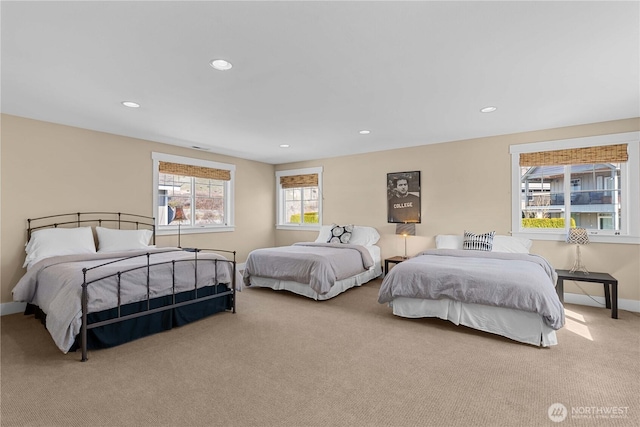 carpeted bedroom featuring baseboards and recessed lighting