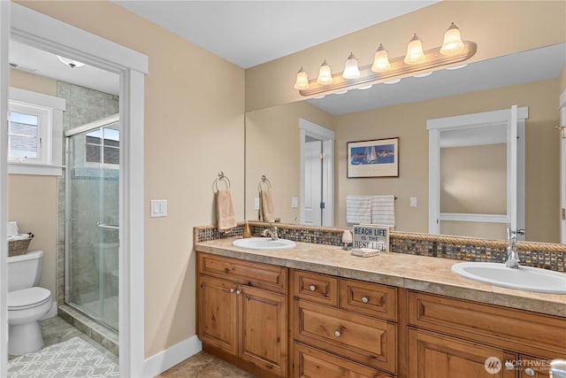 full bathroom with a stall shower, tile patterned floors, toilet, and a sink