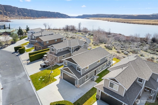 bird's eye view featuring a residential view and a water view