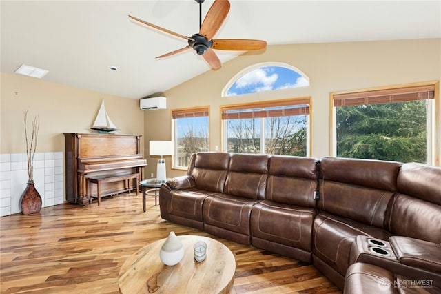 living room featuring wood finished floors, a wall mounted AC, lofted ceiling, and ceiling fan