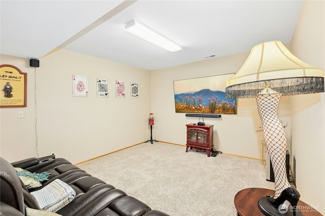carpeted living room featuring baseboards, visible vents, and a wood stove