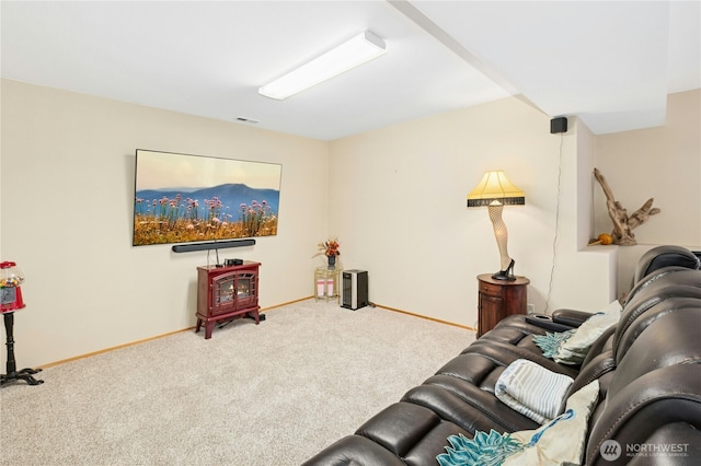 carpeted living area with baseboards and visible vents