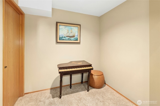 sitting room with carpet floors and baseboards