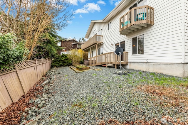 exterior space with a balcony and fence