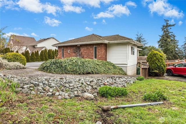 view of side of home with brick siding