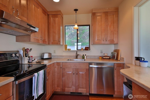 3545 Shell St, Greenbank, WA 98253 - kitchen featuring pendant lighting, appliances with stainless steel finishes, under cabinet range hood, light countertops, and a sink