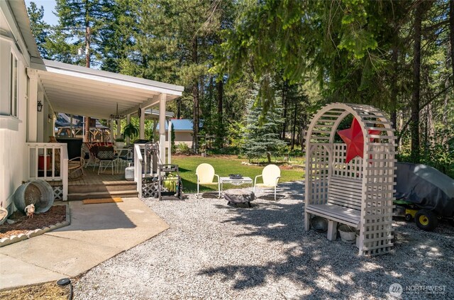 24502 Saddle St, Leavenworth, WA 98826 - view of yard featuring a wooden deck and an outdoor fire pit