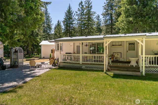 24502 Saddle St, Leavenworth, WA 98826 - rear view of property featuring a lawn, a porch, and metal roof
