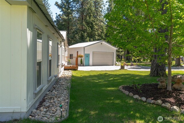 24502 Saddle St, Leavenworth, WA 98826 - view of green lawn with an outdoor structure and a garage