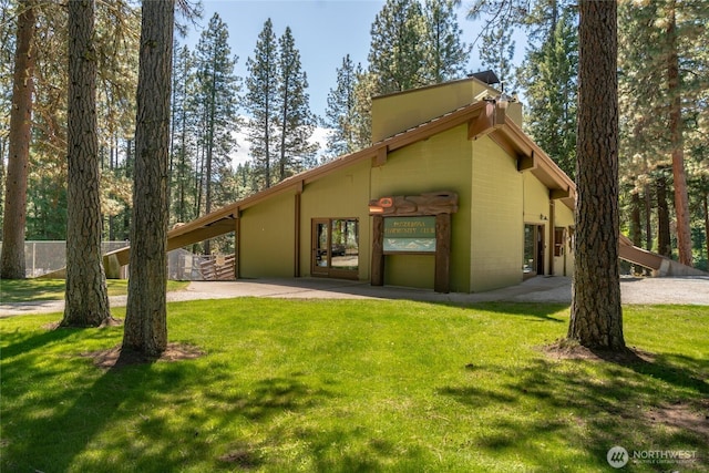 24502 Saddle St, Leavenworth, WA 98826 - back of house with a lawn and a chimney