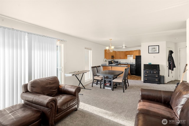 1425 S Puget Dr Unit 213, Renton, WA 98055 - living room with light carpet and a notable chandelier