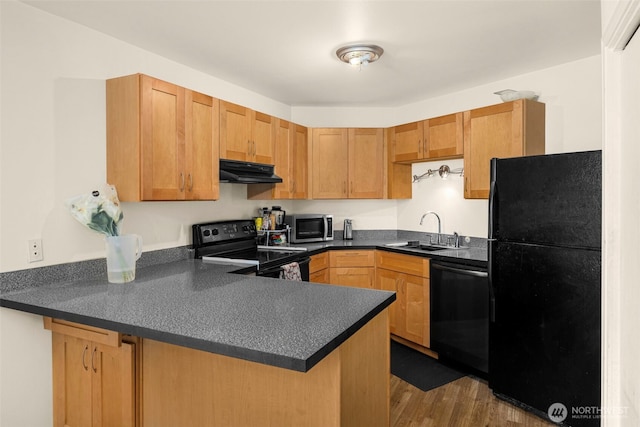 1425 S Puget Dr Unit 213, Renton, WA 98055 - kitchen featuring a peninsula, dark countertops, under cabinet range hood, a sink, and black appliances