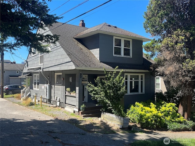 261 E Boston St, Seattle, WA 98102 - view of front of home with a porch, roof with shingles, and a chimney
