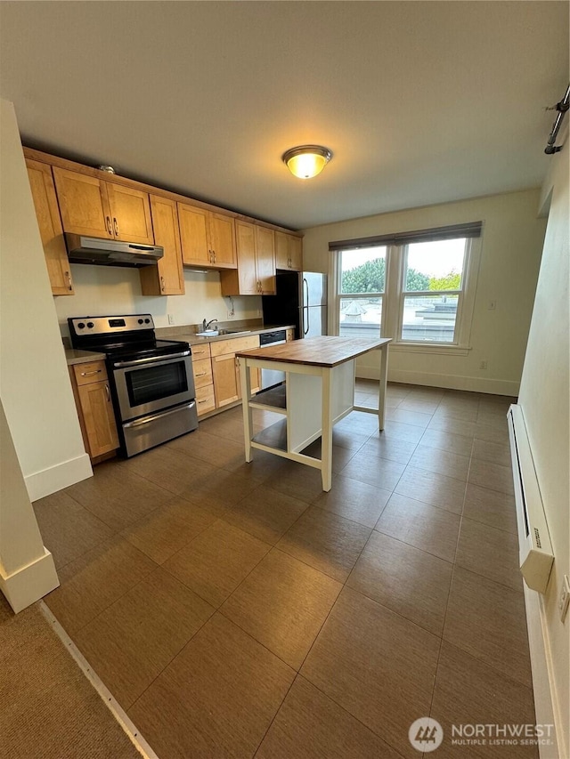 261 E Boston St, Seattle, WA 98102 - kitchen featuring baseboard heating, under cabinet range hood, a sink, stainless steel electric stove, and freestanding refrigerator