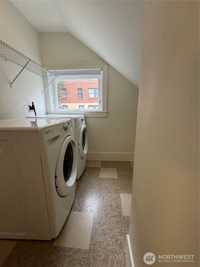 261 E Boston St, Seattle, WA 98102 - laundry area with tile patterned floors, baseboards, washer and dryer, and laundry area