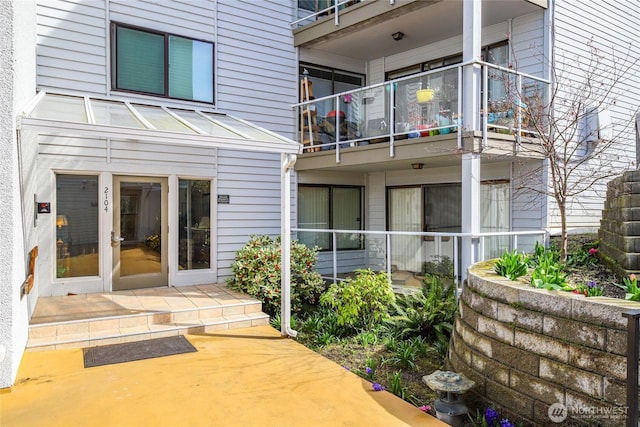 rear view of house with a balcony and a patio area