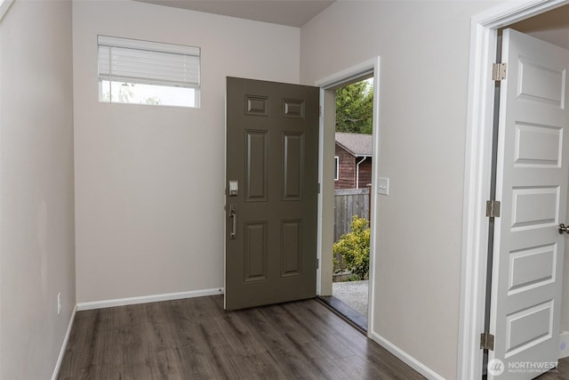 foyer entrance featuring baseboards and dark wood-style flooring