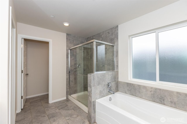 full bath featuring a garden tub, a stall shower, and a wealth of natural light