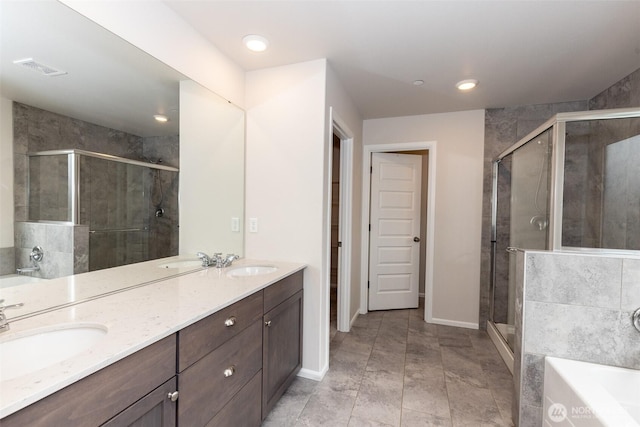 full bathroom with a garden tub, a sink, a stall shower, and double vanity