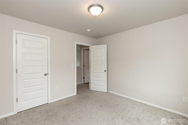 unfurnished bedroom with carpet flooring and baseboards