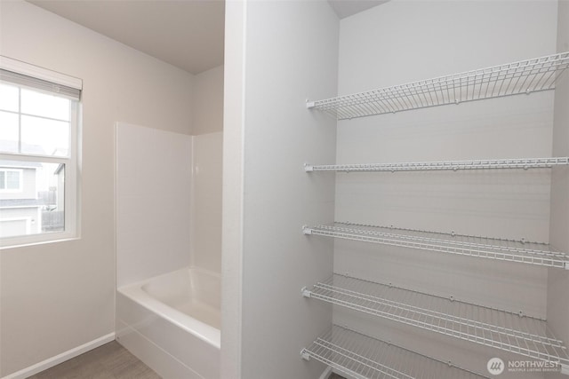 bathroom featuring baseboards and wood finished floors