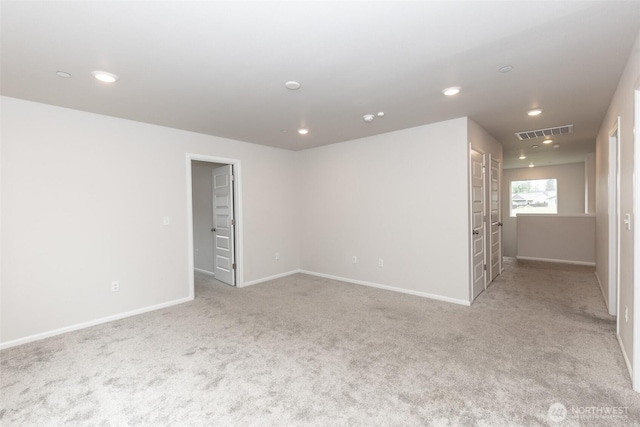 spare room featuring recessed lighting, baseboards, visible vents, and carpet
