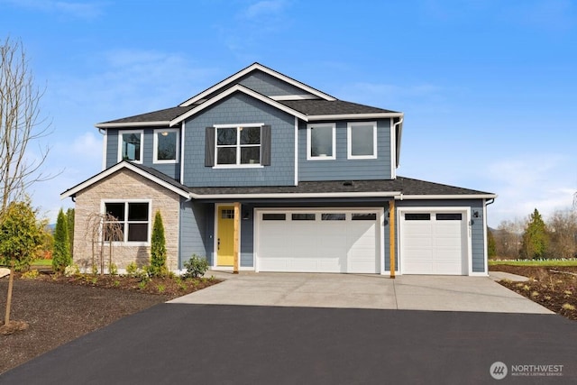 craftsman house with a garage, roof with shingles, and concrete driveway