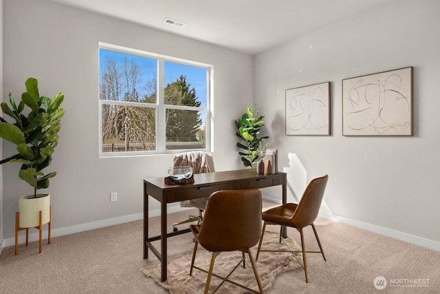 carpeted home office featuring baseboards and visible vents