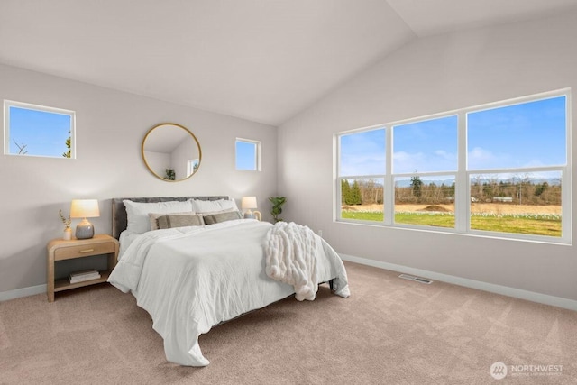 carpeted bedroom with lofted ceiling, baseboards, and visible vents