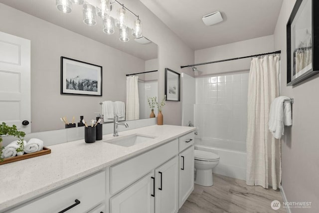 full bathroom featuring marble finish floor, toilet, vanity, and shower / bathtub combination with curtain