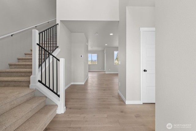 entrance foyer featuring stairway, baseboards, wood finished floors, and recessed lighting