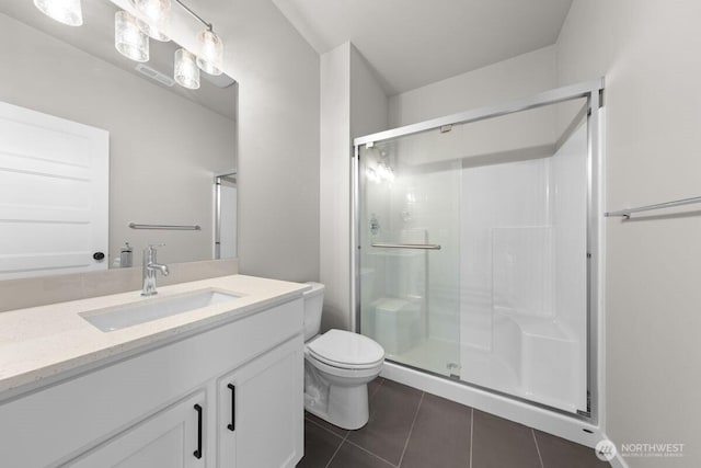 bathroom with vanity, tile patterned flooring, a stall shower, and toilet