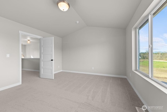 unfurnished bedroom with baseboards, vaulted ceiling, and carpet flooring