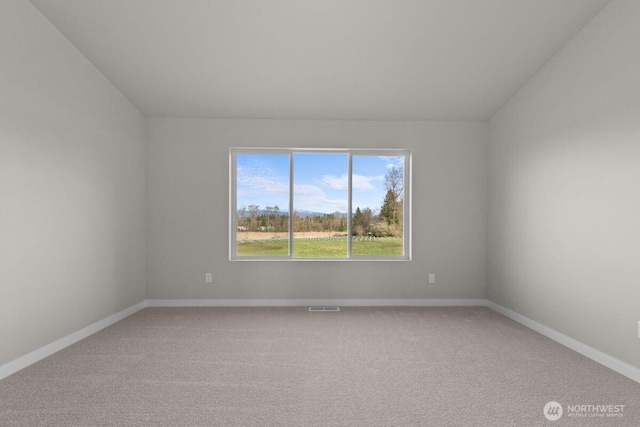 unfurnished room with baseboards, visible vents, and carpet floors