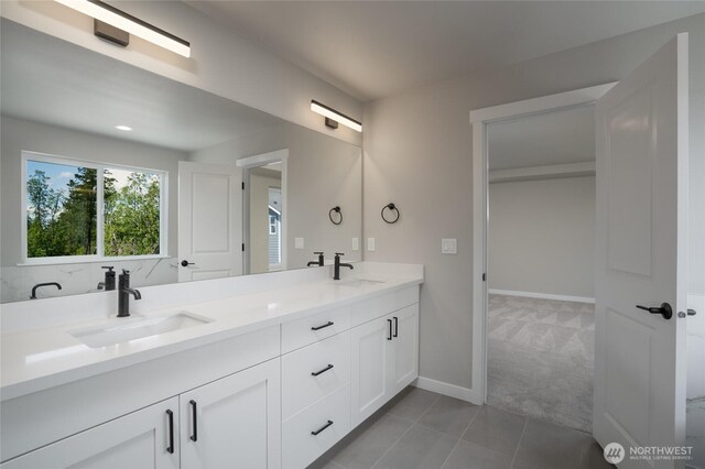 2405 SW Ridgeway Dr, Oak Harbor, WA 98277 - bathroom featuring double vanity, tile patterned floors, and baseboards