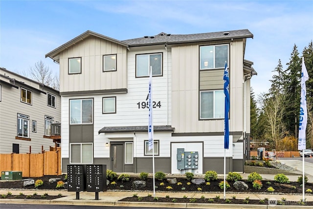 view of front of house featuring board and batten siding and fence