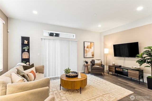 living area with recessed lighting and wood finished floors