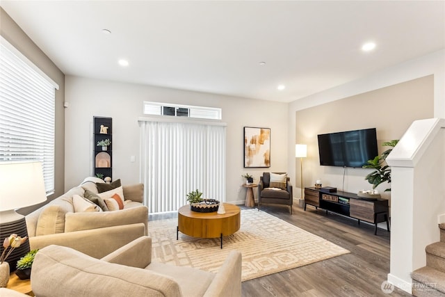 living area with recessed lighting, stairs, and wood finished floors