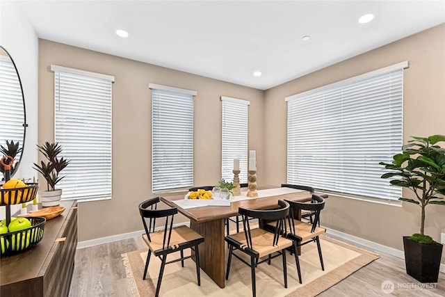 dining area with light wood finished floors, baseboards, and recessed lighting
