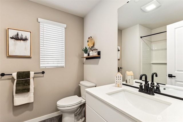 bathroom featuring toilet, walk in shower, and vanity