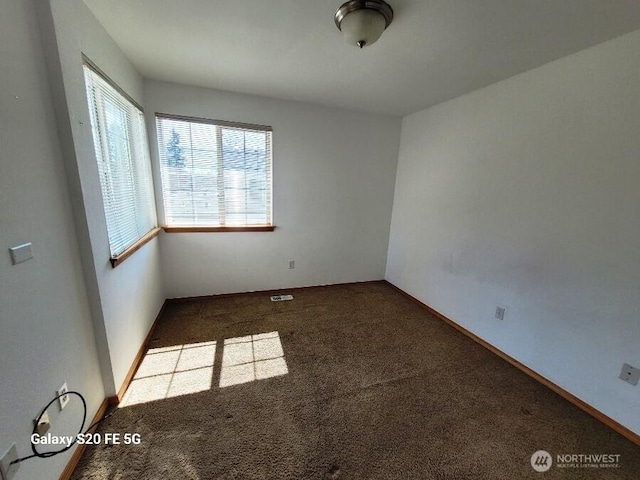 carpeted empty room with baseboards