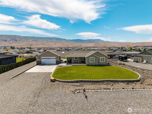 206 Moon River Vw SW, Mattawa, WA 99349 - ranch-style house featuring a residential view, concrete driveway, a mountain view, and a garage