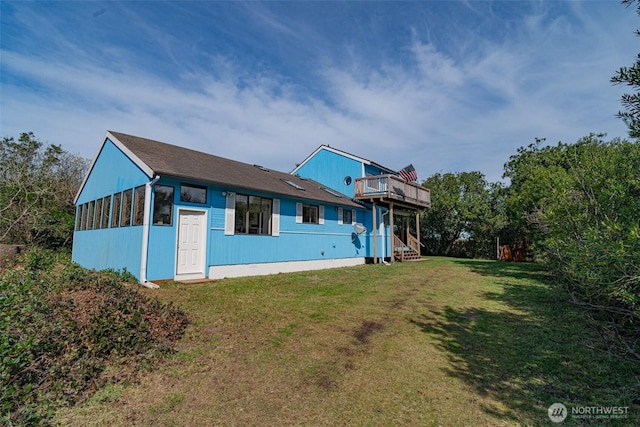 rear view of property with a yard