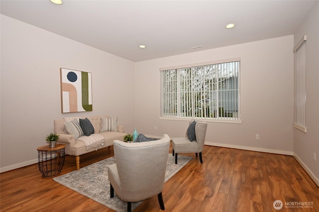 living area with recessed lighting, baseboards, visible vents, and wood finished floors