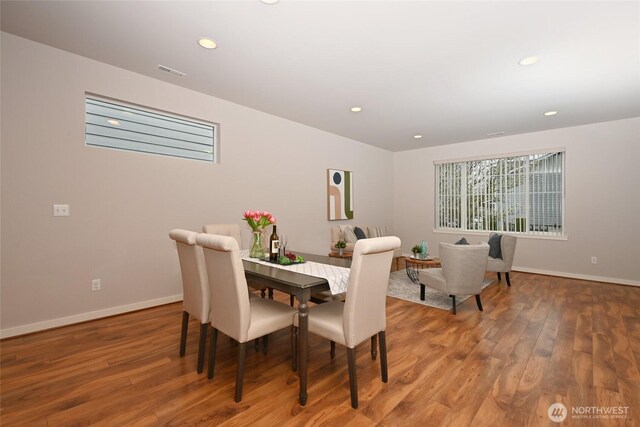 dining room featuring baseboards, visible vents, wood finished floors, and recessed lighting