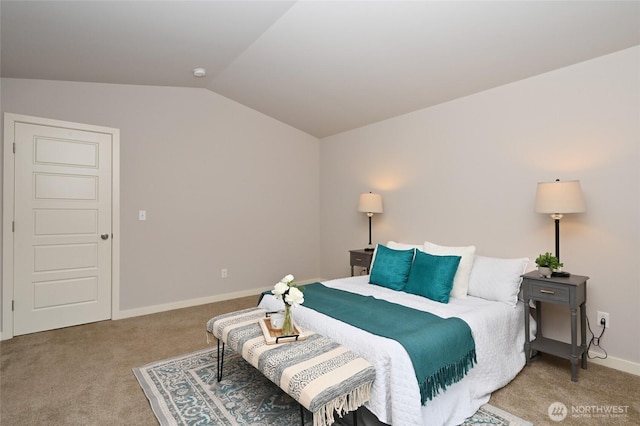 carpeted bedroom with baseboards and vaulted ceiling